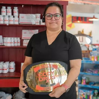 staff member holding Cody Drug belt