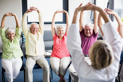 seniors doing chair yoga